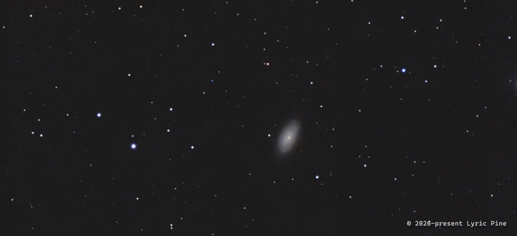 The Black Eye Galaxy (Messier 64): a bright spiral galaxy with a dark band of dust across its core.