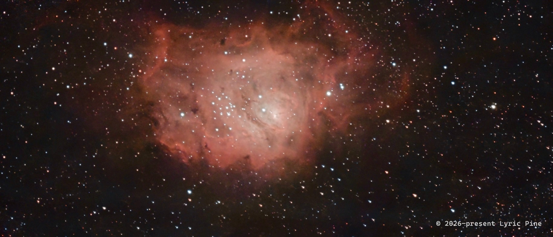 The Lagoon Nebula (Messier 8): glowing pink clouds of hydrogen gas around a bright cluster of newborn stars.