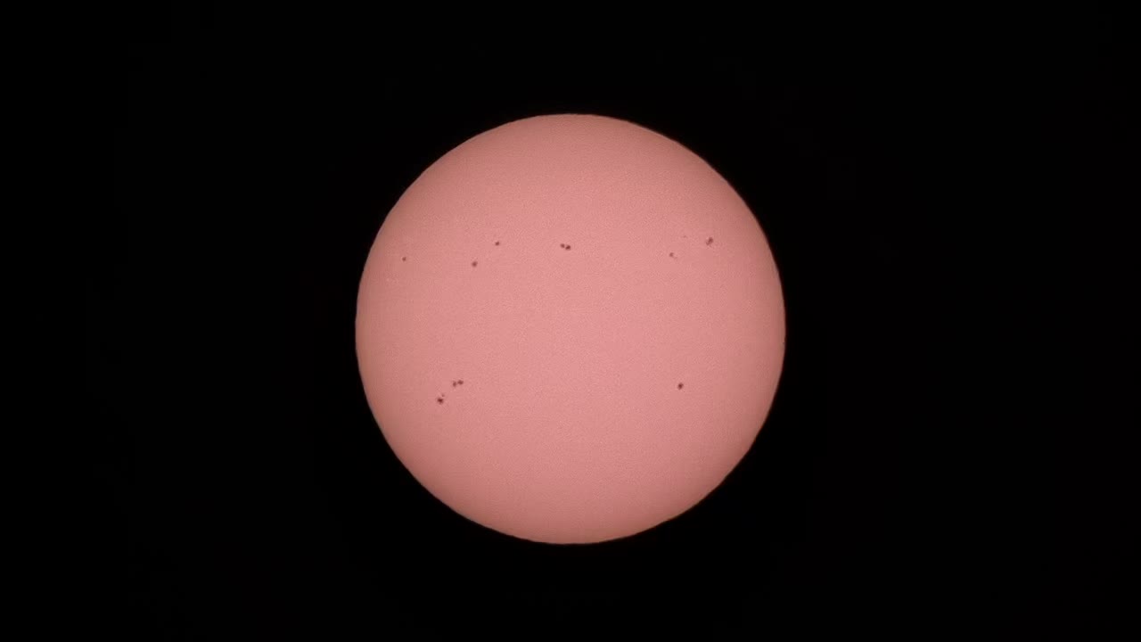 The Sun filmed through a telescope with a solar filter, a churning sphere of plasma.